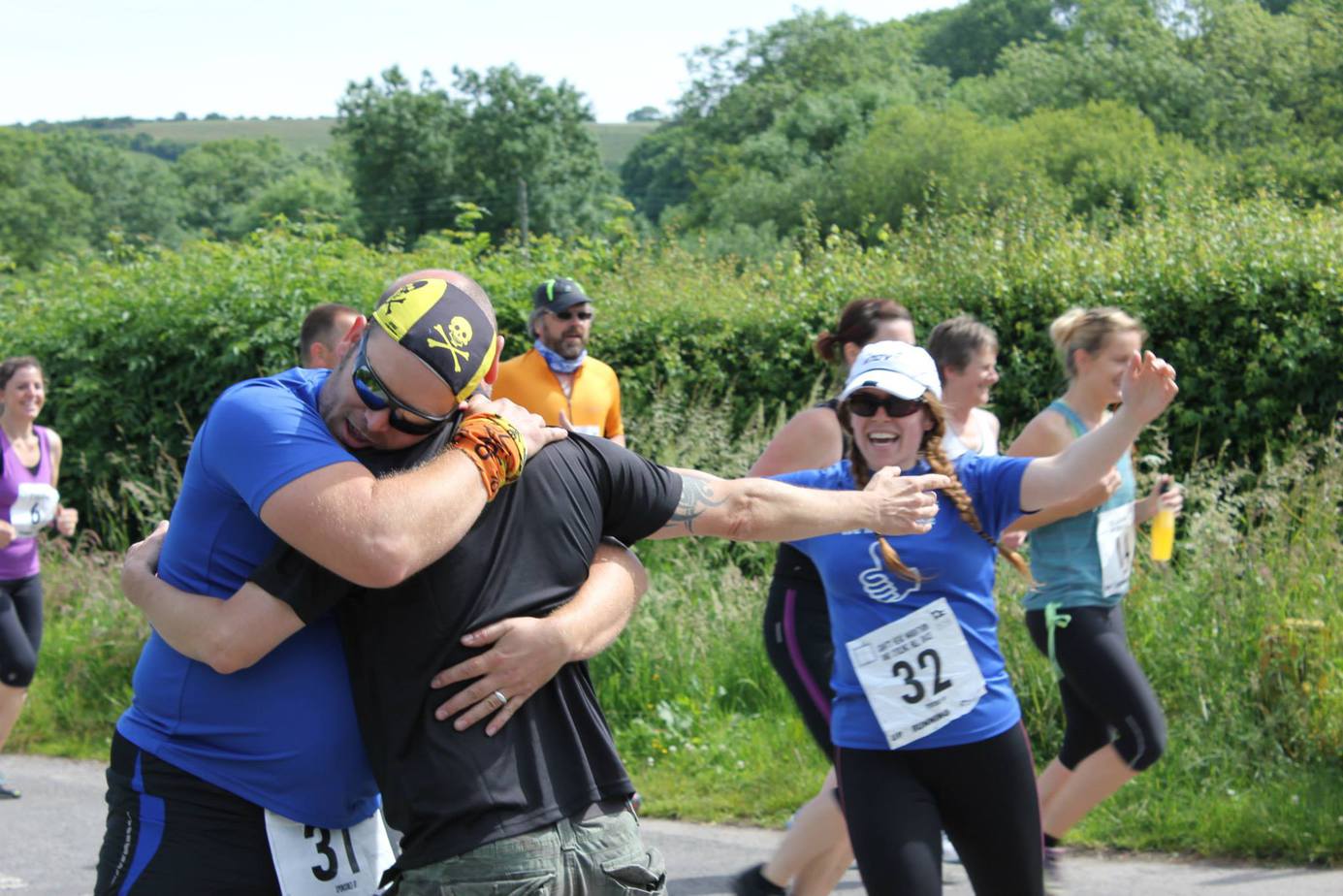 Runners hugging on the running event route